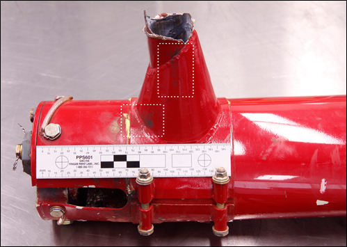 Figure 2: Fractured stabiliser attachment bracket with black dust outlined in white (in two places)